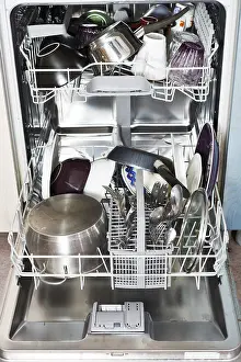Household Appliance Maintenance Drucke: Dirty cookware in open kitchen dishwasher