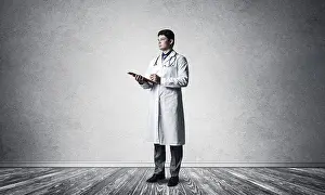 Self Confident Doctor Drucke: Doctor with a tablet with documents