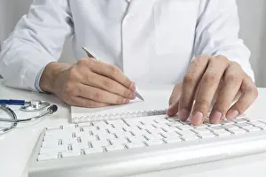 Healthcare Professional Advice Drucke: Doctor typing on wireless computer keyboard in office