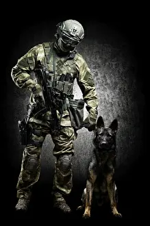 German Shepherd Breed Drucke: Dog handler posing in the studio with a trained shepherd