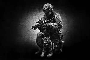 German Shepherd Breed Drucke: Dog handler posing in the studio with a trained shepherd
