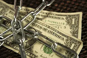 Brown Background Studio Shot Drucke: One Dollar notes in chains studio shot over brown background