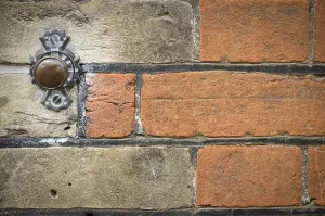 Northern European Architecture Drucke: Door bell button on brick wall