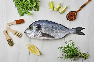 Gourmet Seafood Dish Drucke: Dorada fish on the table with spice and herbs