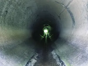 Deserted Street Photography Drucke: Drainage pipe under the highway (culvert)
