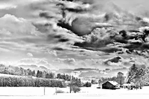 Cloudy Sky Southern Germany Drucke: Dramatic black and white landscape with clouds and snow