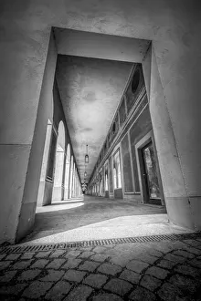 Upper Bavaria Photography Drucke: A dramatic black and white view through a colonnade with light and shadow effects