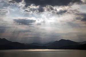 Lago Maggiore Italy Drucke: Dramatic cloud formation, sunbeams behind dark clouds