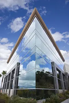 High Rise Structure Drucke: Dramatic corporate building with blue sky and clouds