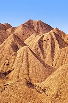 Lonely Mountain Range View Drucke: Dramatic details of the eroded orange ridges at Devil's Desert located in Salta