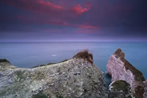 Atmospheric Sunrise Photography Drucke: Dramatic red sunrise over cliffs in ocean