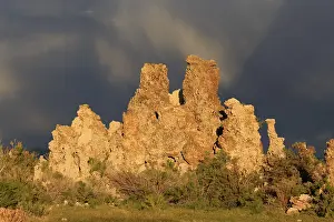 Atmospheric Evening Skies Drucke: Dramatic rock formations against a cloudy sky at dusk