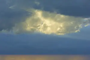 Western Europe Landscape Drucke: Dramatic sky with bright clouds in the sunlight shining through a gap