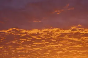 Central European River Landscape Drucke: Dramatic sky with orange-red clouds at sunrise