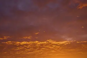 Cloudy Skies Southern Germany Drucke: Dramatic sky with orange-red clouds at sunrise