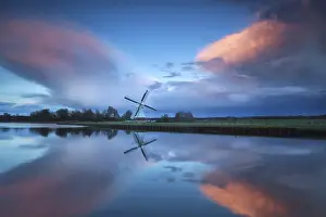 Benelux Countryside Scene Drucke: Dramatic stormy sunset over Dutch windmill and river