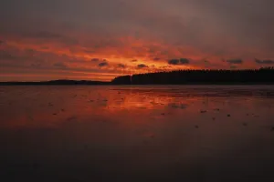 Frozen Lake Landscape Photography Drucke: A dramatic sunset over a still