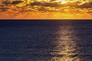 Cloudy Landscape Photography Drucke: Dramatic sunset at the sea, sunbeams behind clouds