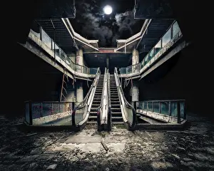 Dark Night Sky Drucke: Dramatic view of damaged escalators in abandoned building
