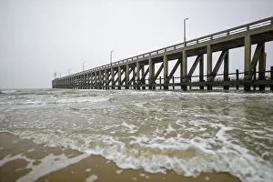 Beach Resorts In Europe Drucke: Dramatic view on pier from water with waves and concrete