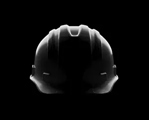 Industrial Equipment Drucke: Dramatically lit hard hat isolated on a black background