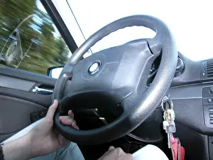 Close Up Steering Wheel Drucke: Driving with one hand