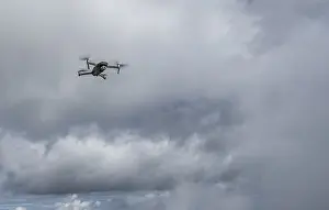 Upper Bavaria Aerial View Drucke: Drone with camera flies in front of clouds