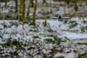 Winter Landscape Southern Germany Drucke: A drone flies over a wintry forest with light snowfall