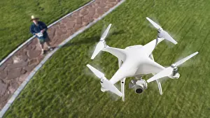 Radio Controlled Aircrafts Drucke: Drone quadcopter (UAV) in air above pilot with remote controller