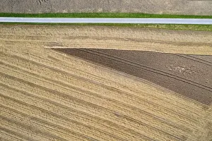Austrian Countryside Travel Drucke: Drone shot, road through harvested fields with abstract patterns