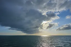 Northern Europe Dusk Scene Drucke: Dusk at sea with dramatic clouds and light in the background