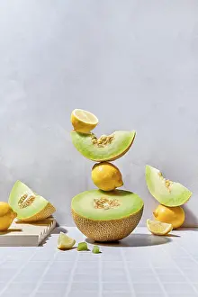 Vibrant Fruit Display Drucke: A dynamic arrangement of melons and lemons on a tiled surface