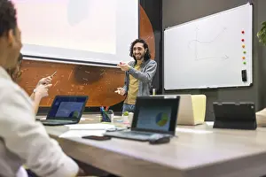 Office Communication Skills Drucke: A dynamic office setting with a diverse team engaged in a presentation
