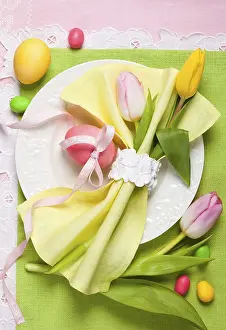 Easter table setting with tulips and easter eggs
