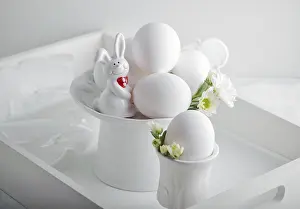 Pastel Colored Flowers Drucke: Eggs, rabbit and flowers on a white surface