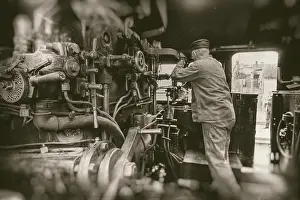 Deserted Railway Station Drucke: Engine driver working on steam train engine