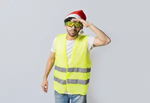 Santa Hat Portrait Drucke: Engineer in christmas hat looking at something in the distance