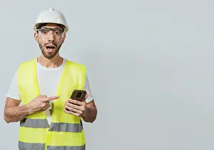 Young Adult Man Drucke: Engineer using and pointing at cellphone