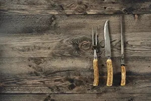 Country Style Kitchen Drucke: Three essential barbecue tools on a rustic kitchen table made of dark wood