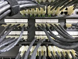 Ethernet Cable Connection Drucke: Ethernet cables connected from patch panel to the network equipment with green lights