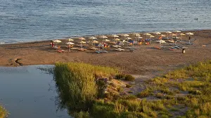 Evening Beach Scene Drucke: Evening light, beach, umbrellas