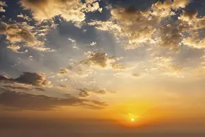 Evening Landscape Photography Drucke: Evening sunset sky with sun and dramatic clouds