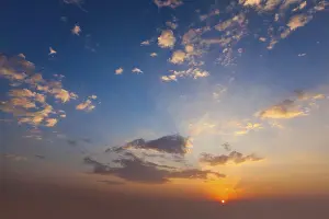 Atmospheric Evening Mood Drucke: Evening sunset sky with sun and dramatic clouds