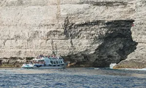 Rocky Coastline Photos Drucke: Excursion boat visiting cave in chalk cliffs