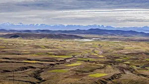 Andes Landscape Drucke: Extensive fields with mountains on the horizon and cloudy sky