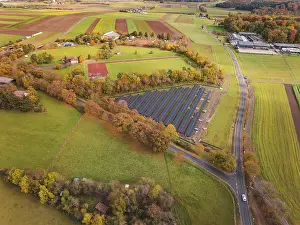 Solar Panel Installation Germany Drucke: Extensive view of solar systems between fields and autumn trees