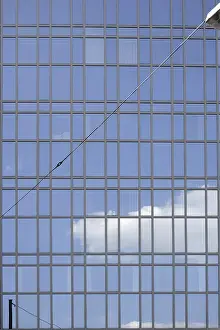 Modern Office Building Facade Drucke: The facade of a modern office building with cloud reflections in the windows
The fa