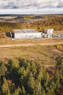 Industrial Area In Europe Drucke: Factory building next to forest and clearing