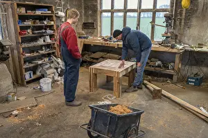 Family Bonding Moments Drucke: Father and son looking at the table built by the son in the workshop