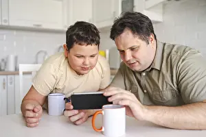 Morning Kitchen Scene Drucke: A father and son sit at a kitchen table